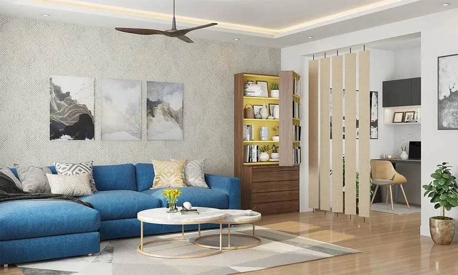 odern living area with blue sofa, workspace partition, and wall art