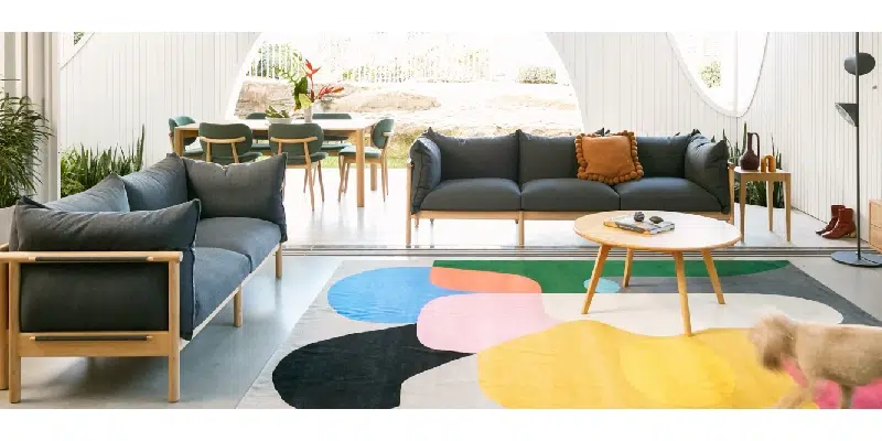 Ground floor living area with garden view and black sofas