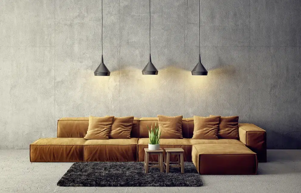 Cozy living room with warm lighting, grey walls, sofa, and area rug