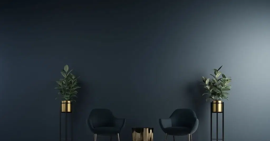 Minimalist living area with dark walls, black chairs, and gold accent table