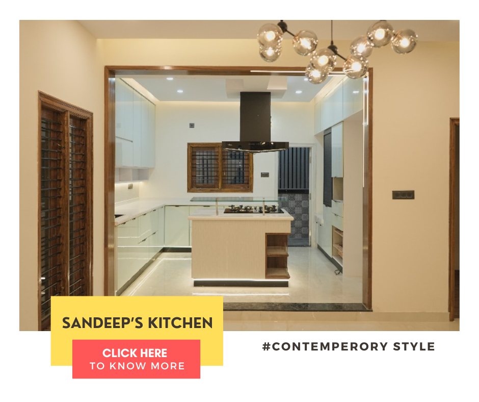 A contemporary kitchen interior design by Olangana in Bangalore, featuring elegant white cabinetry, a stylish island hob, and modern lighting, exemplifying functional beauty.