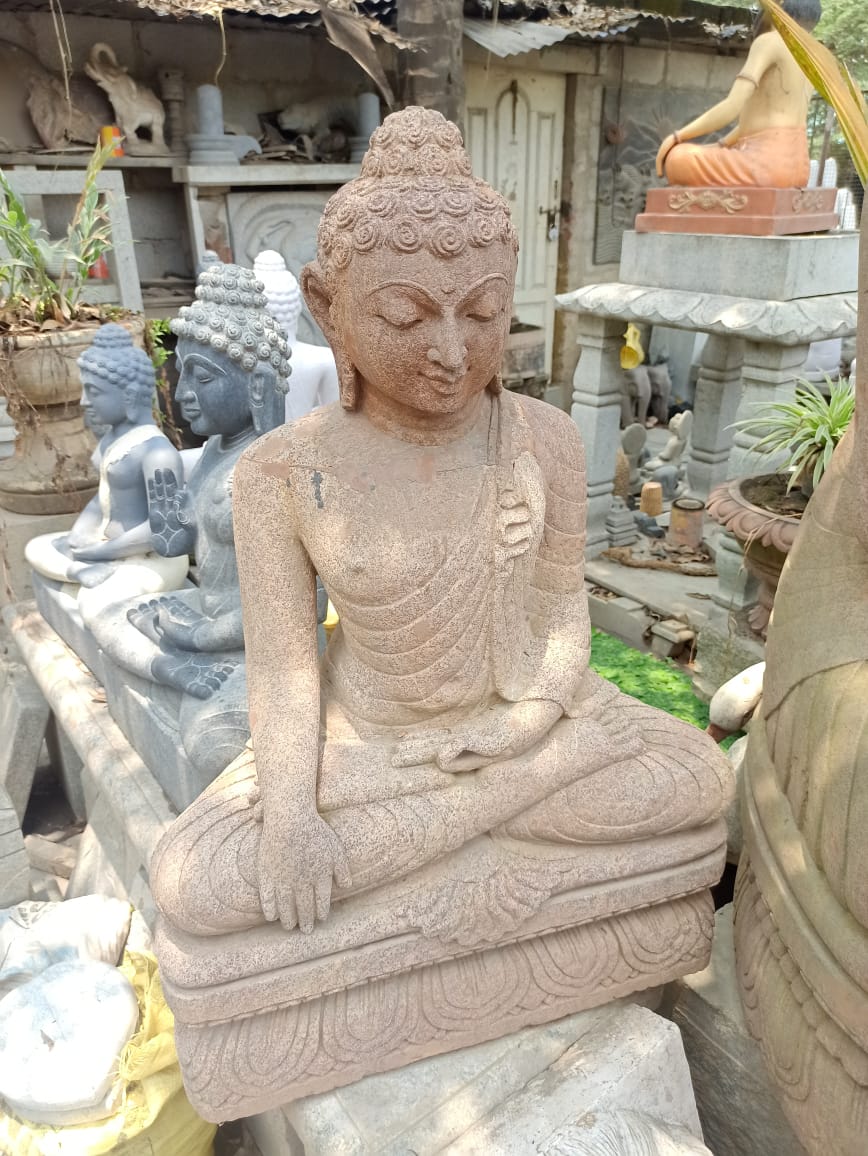 Serene brown stone Buddha statue in a meditative pose, a source of inspiration for spiritual interior designs by Olangana Design in Bangalore.