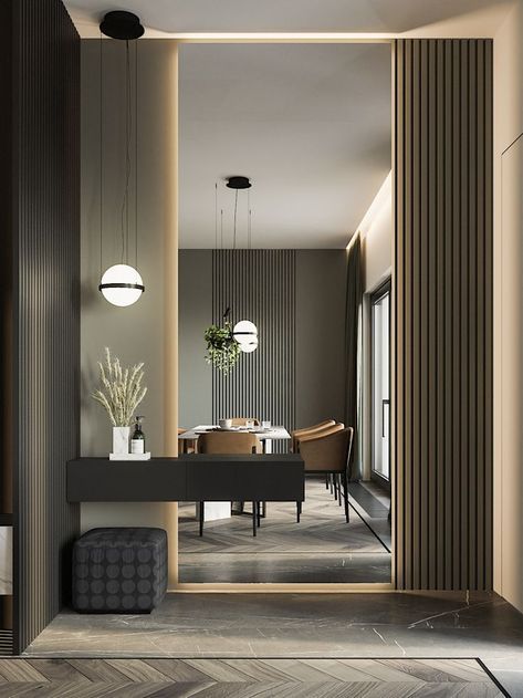 Modern interior design entryway by Olangana Design in Bangalore, featuring a sleek dark console table, stylish pendant lighting, textured wall panels, and a glimpse into a contemporary dining area.