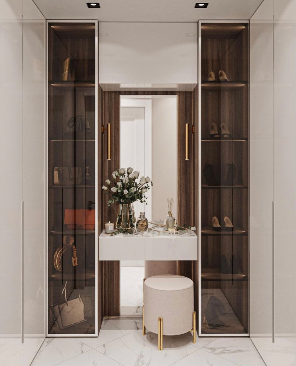 Luxury modern walk-in closet interior design by Olangana Design in Bangalore, featuring display cabinets, vanity table, and elegant decor with marble flooring.