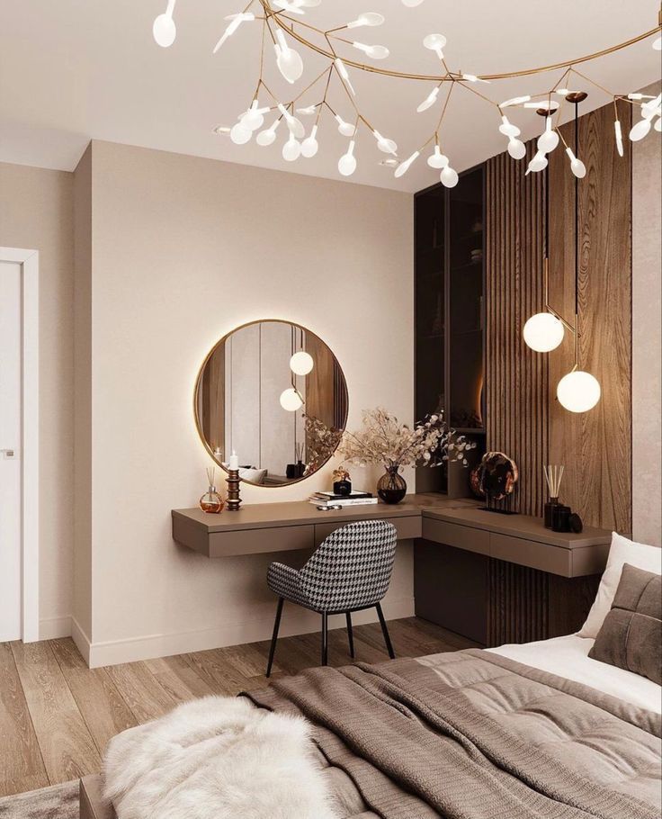 Modern bedroom interior with floating vanity, round illuminated mirror, unique branch chandelier, and stylish wooden accent wall, a premium design by Olangana Design in Bangalore.