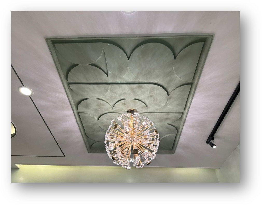 Luxurious false ceiling design with geometric patterns and crystal chandelier, a stunning interior by Olangana Design in Bangalore.