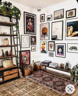 Eclectic living room interior design by Olangana in Bangalore, featuring a vibrant gallery wall, industrial-style shelving, a bohemian rug, and rustic wooden floors.