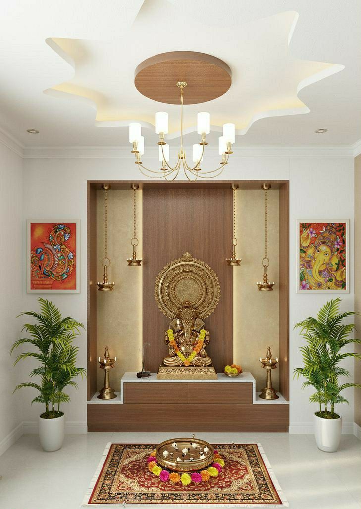 Exquisite puja room interior design by Olangana in Bangalore, featuring a golden Ganesha idol, traditional brass hanging lamps, a modern false ceiling with cove lighting, and elegant wooden cabinetry. This serene space blends spiritual tradition with contemporary interior design.