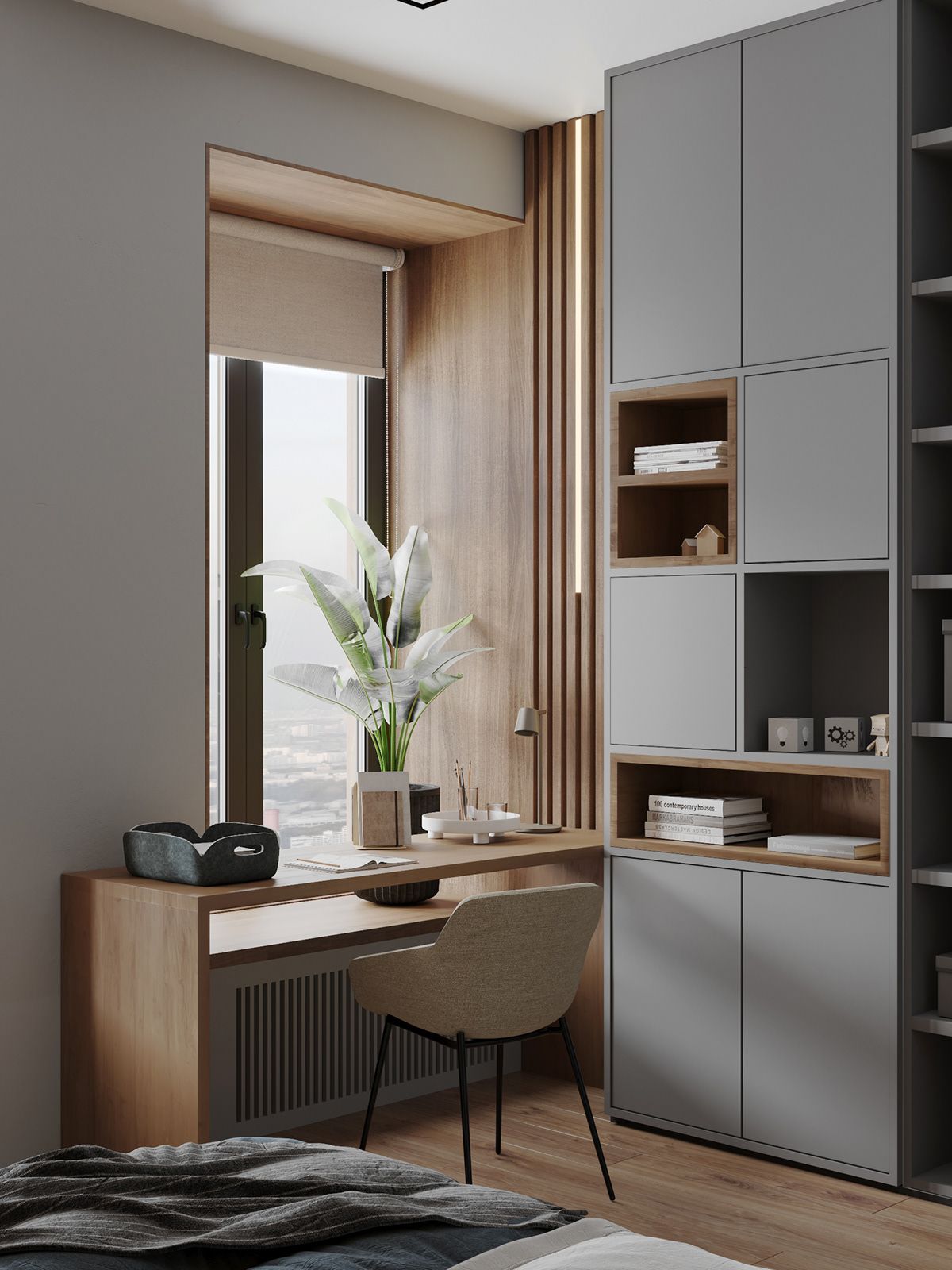 A modern home office interior design by Olangana in Bangalore, featuring a sleek wooden desk by a large window with city views, a comfortable beige chair, and extensive grey built-in cabinetry with natural wood accents. The space is illuminated by natural light and integrated LED strips, showcasing functional and elegant Interior Design.