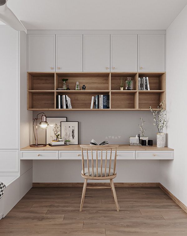 An elegant minimalist home office and study nook by Olangana Design in Bangalore, featuring light grey overhead cabinets, natural wood open shelving filled with books and decor, a floating white and wood desk, and a stylish light wooden chair. This Interior Design blends functionality with serene aesthetics, perfect for a modern Bangalore home.