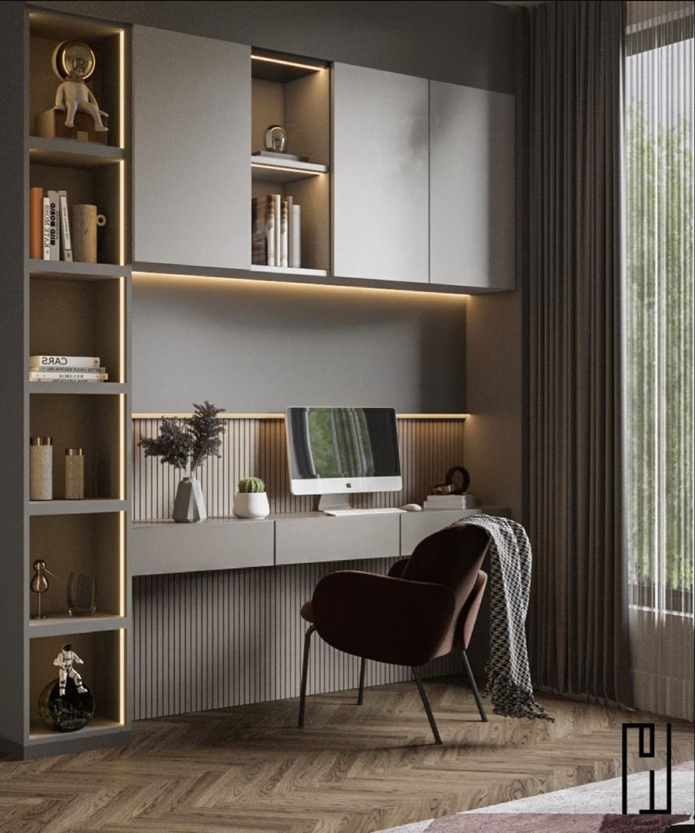 A sophisticated grey home office and study area by Olangana Design in Bangalore, featuring integrated shelving, a modern desk with warm LED accent lighting, a comfortable brown upholstered chair, and herringbone wood flooring, embodying contemporary Interior Design.