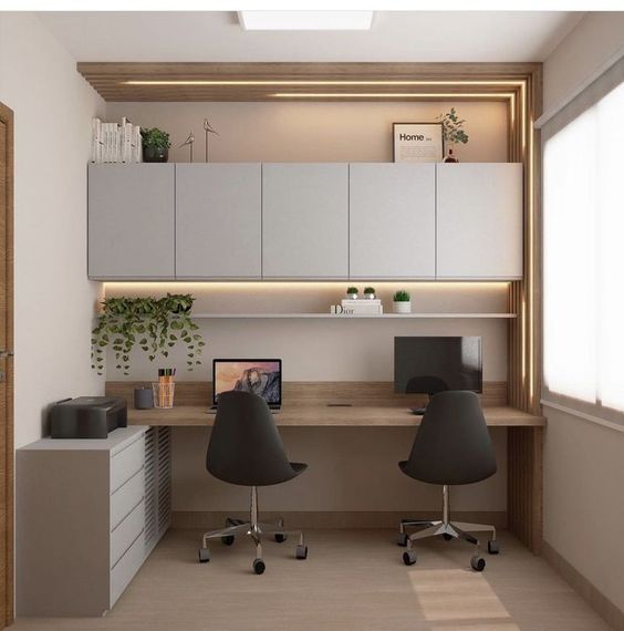 Elegant home office interior design by Olangana in Bangalore, featuring a dual workstation with light wood desks, sleek grey cabinets, integrated LED lighting, and minimalist decor.