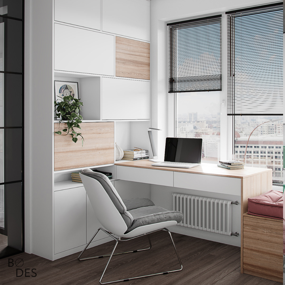 Elegant home office Interior Design by Olangana in Bangalore, showcasing a modern white and light wood integrated desk and custom shelving unit, an ergonomic grey chair, and abundant natural light from large windows overlooking the city.