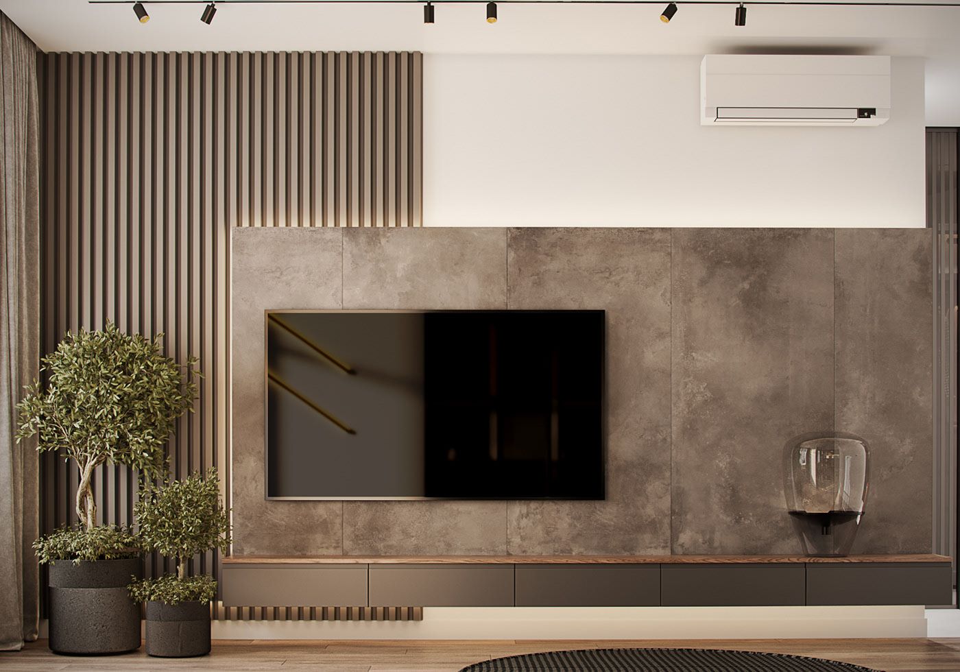 A sleek modern living room interior design by Olangana, featuring a grey textured TV wall, a minimalist floating dark grey console, and elegant vertical slatted panels with integrated ambient lighting. Lush green potted plants add natural charm to this contemporary Bangalore home.