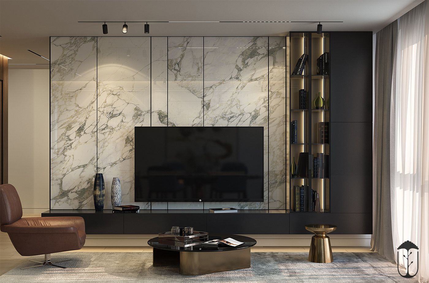 A luxurious modern living room Interior Design by Olangana in Bangalore, featuring a striking white marble media wall, sleek black cabinetry, a comfortable brown leather armchair, and a sophisticated gold coffee table, embodying contemporary elegance.