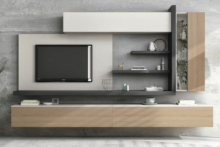 A sleek, modern minimalist TV unit and storage system designed by Olangana, featuring a blend of white, light wood, and dark grey floating shelves against a textured grey wall. This elegant interior design solution is perfect for contemporary homes in Bangalore.