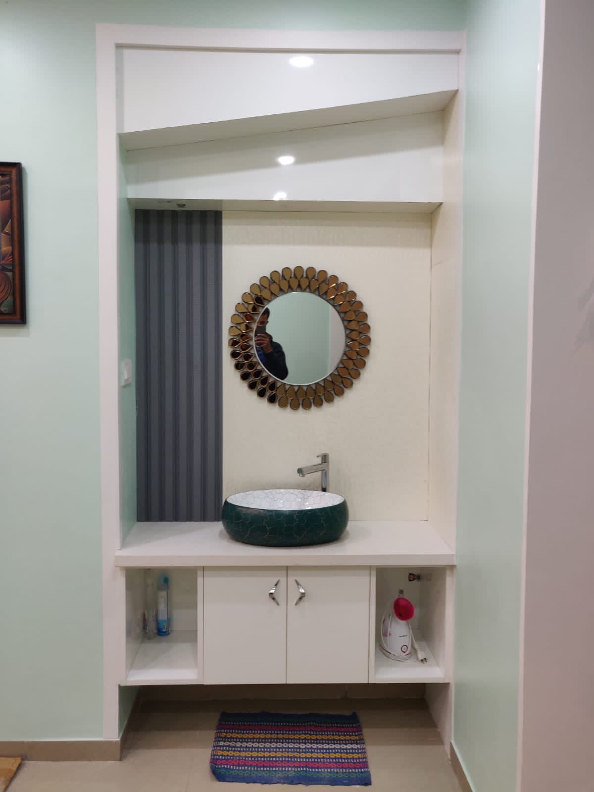 Elegant recessed vanity featuring a striking green ceramic basin, a decorative gold-framed mirror, and integrated storage, expertly designed for modern homes in Bangalore by Olangana Interior Design.