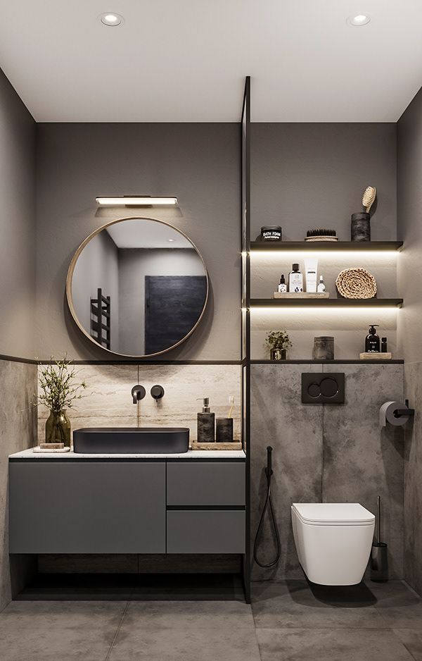 Elegant dark grey bathroom interior design by Olangana in Bangalore, featuring a floating vanity with a black basin, a round gold-framed mirror, ambient backlit shelving, and modern fixtures, showcasing sophisticated Interior Design.