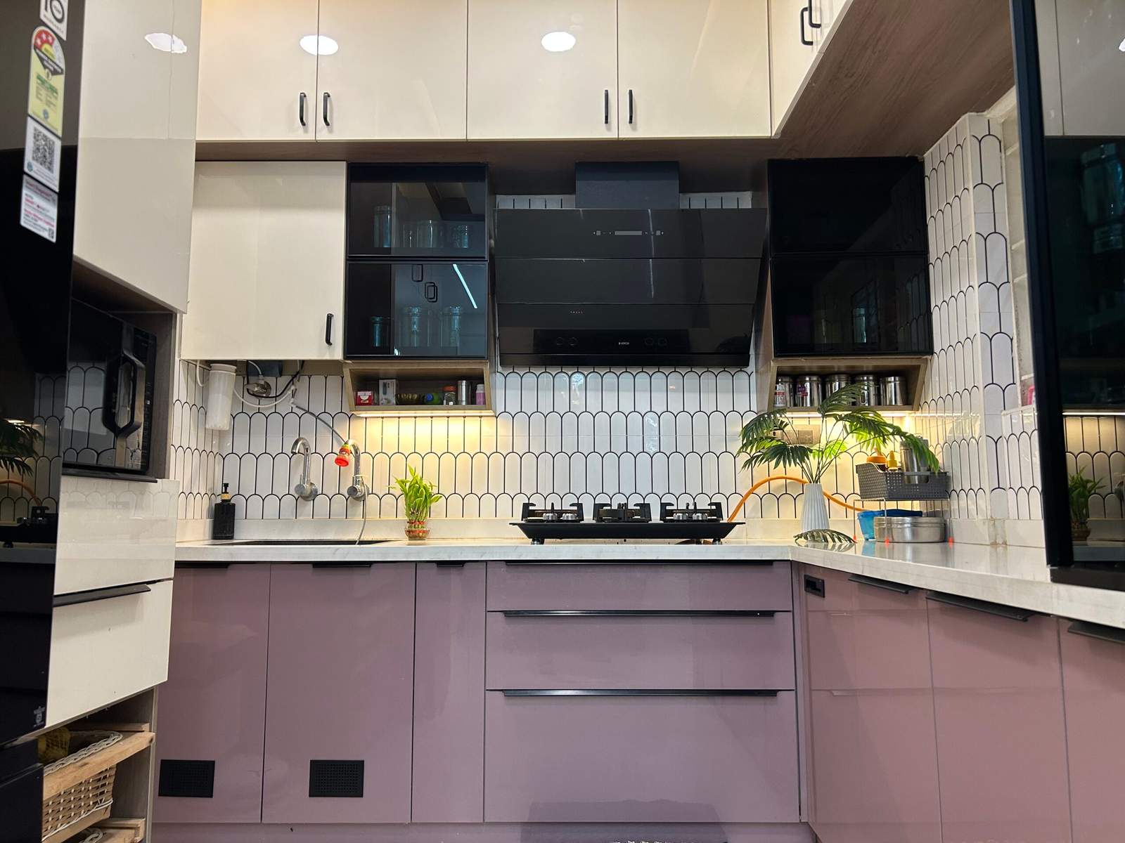 Elegant modular kitchen with modern chimney, stylish handles, and colorful wardrobes for a Bangalore home.
