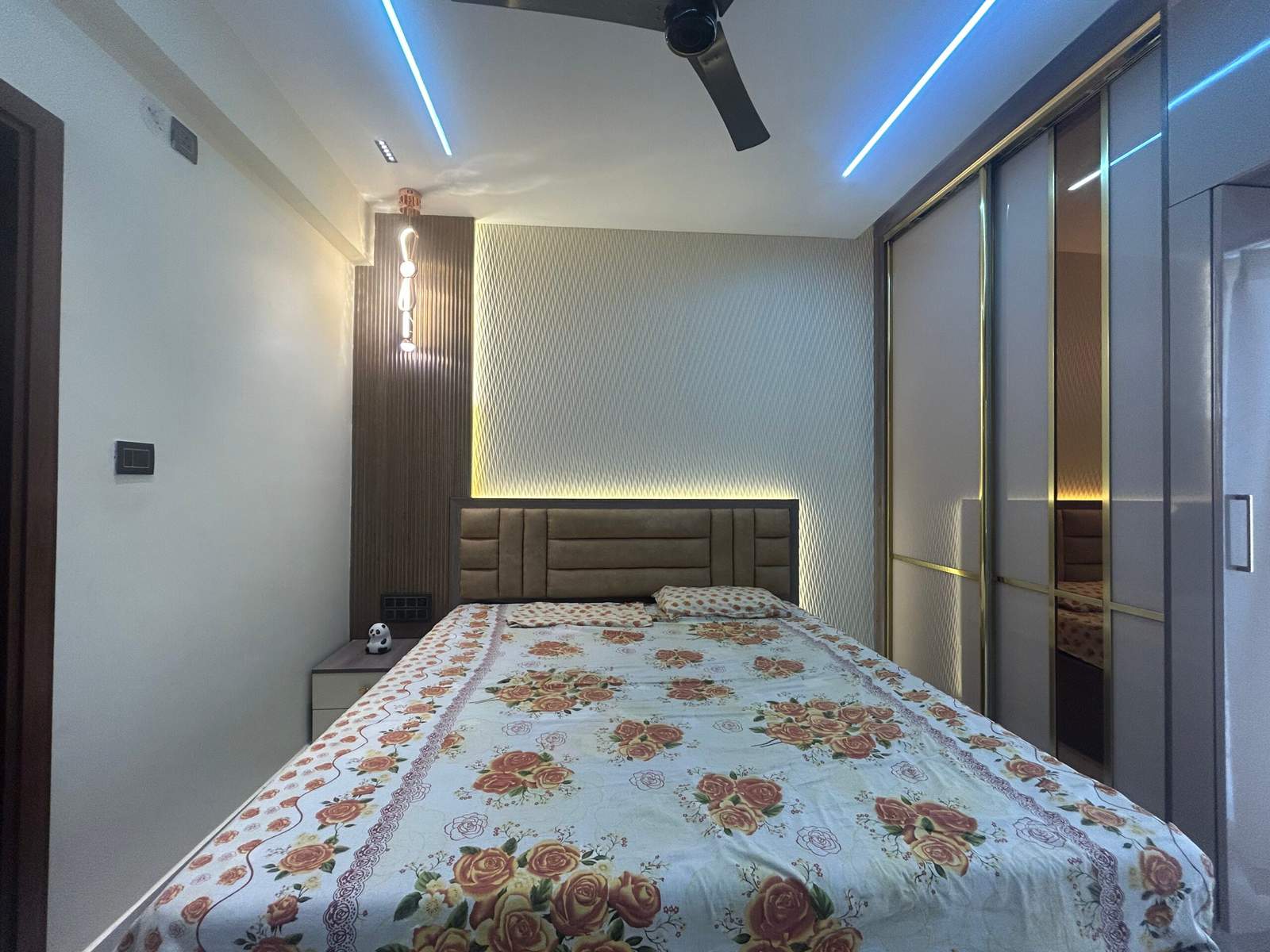 Modern bedroom interior with bedside table and lamp in a Bangalore home by Olangana Design’s.