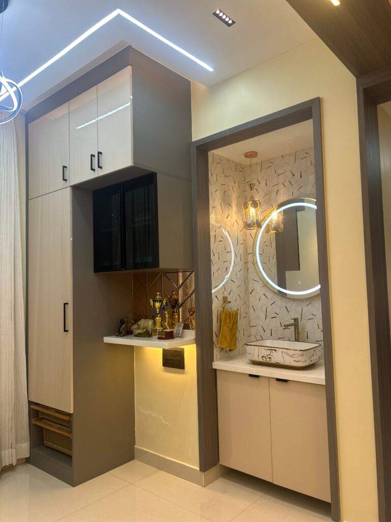 Dining area hand wash unit with LED mirror and storage cabinets in Bangalore home by Olangana Design’s.