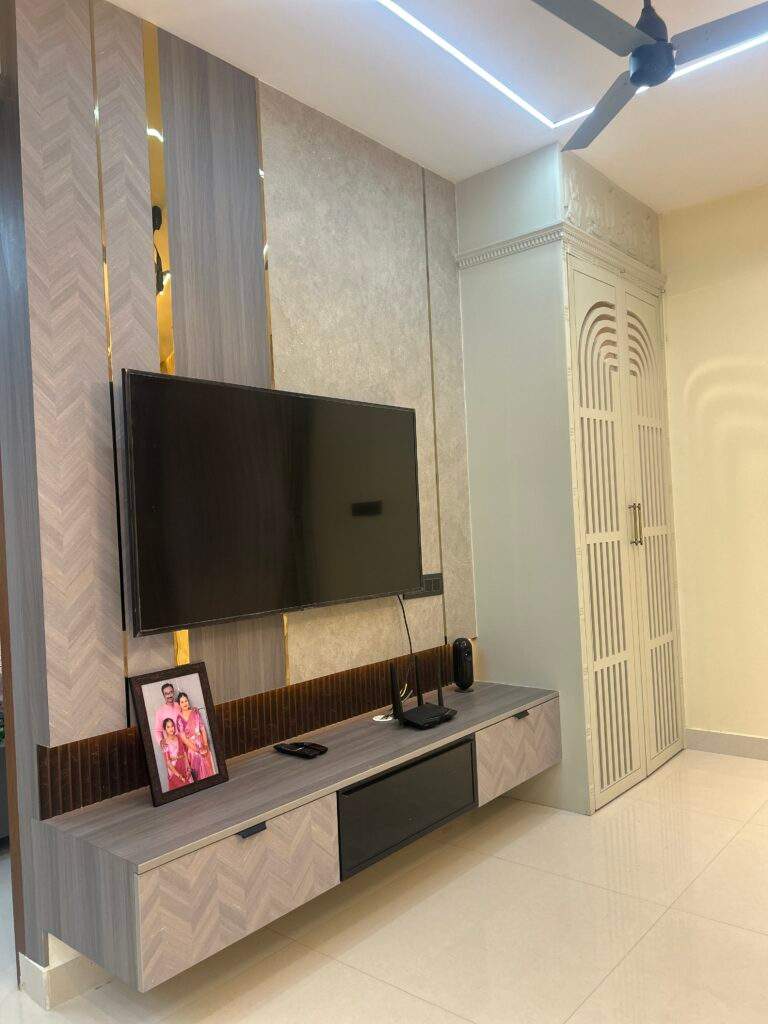 Compact pooja room with enclosed doors in living room near TV cabinet in Bangalore home by Olangana Design’s.
