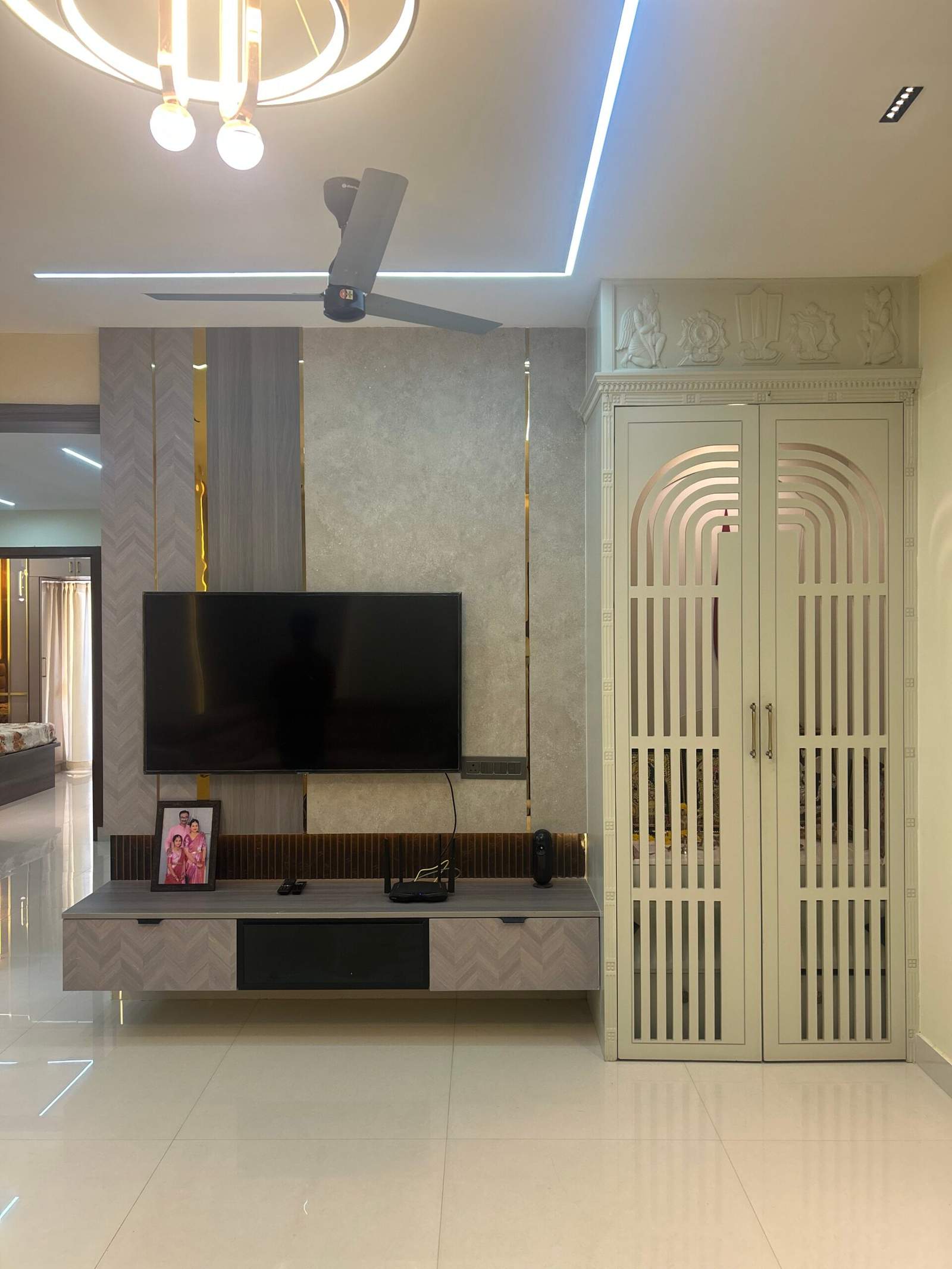 Living hall pooja room with decorative doors near TV unit in Bangalore home by Olangana Design’s.