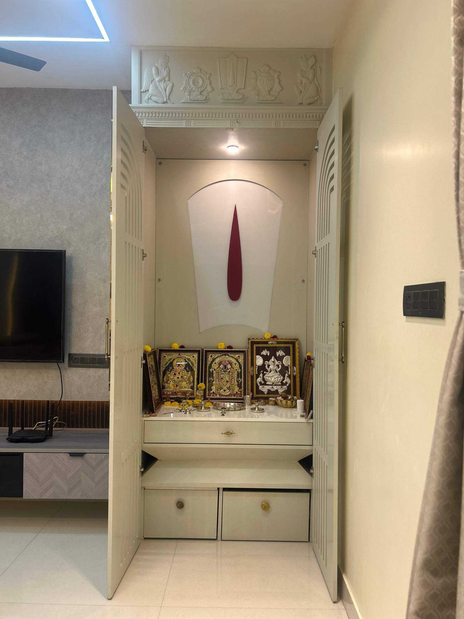 Contemporary pooja room with Nama, Shanka, and Chakra wall décor in Bangalore home by Olangana Design’s.