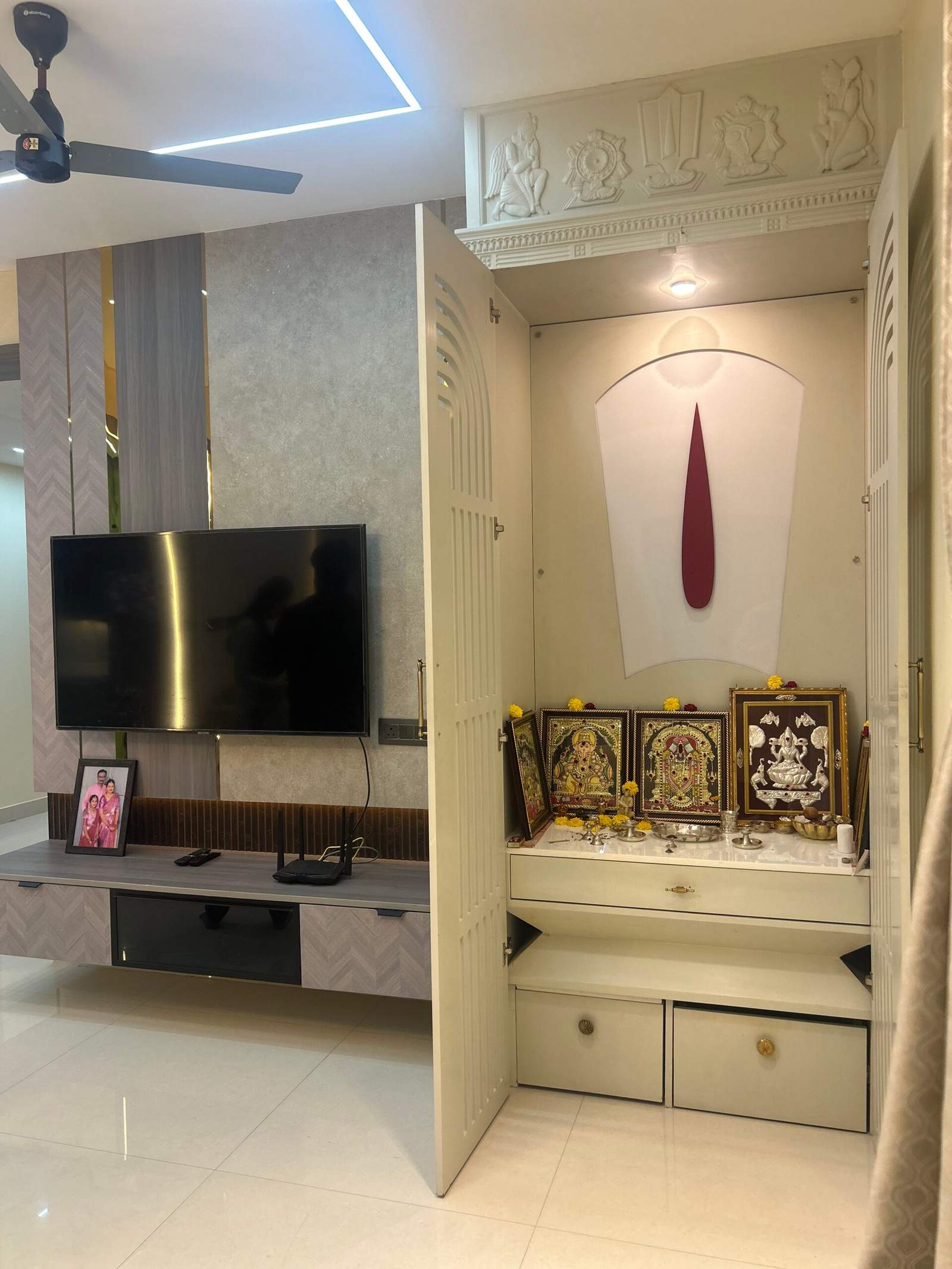 Modern Indian pooja room with Nama, Shanka, and Chakra wall design in Bangalore home by Olangana Design’s.
