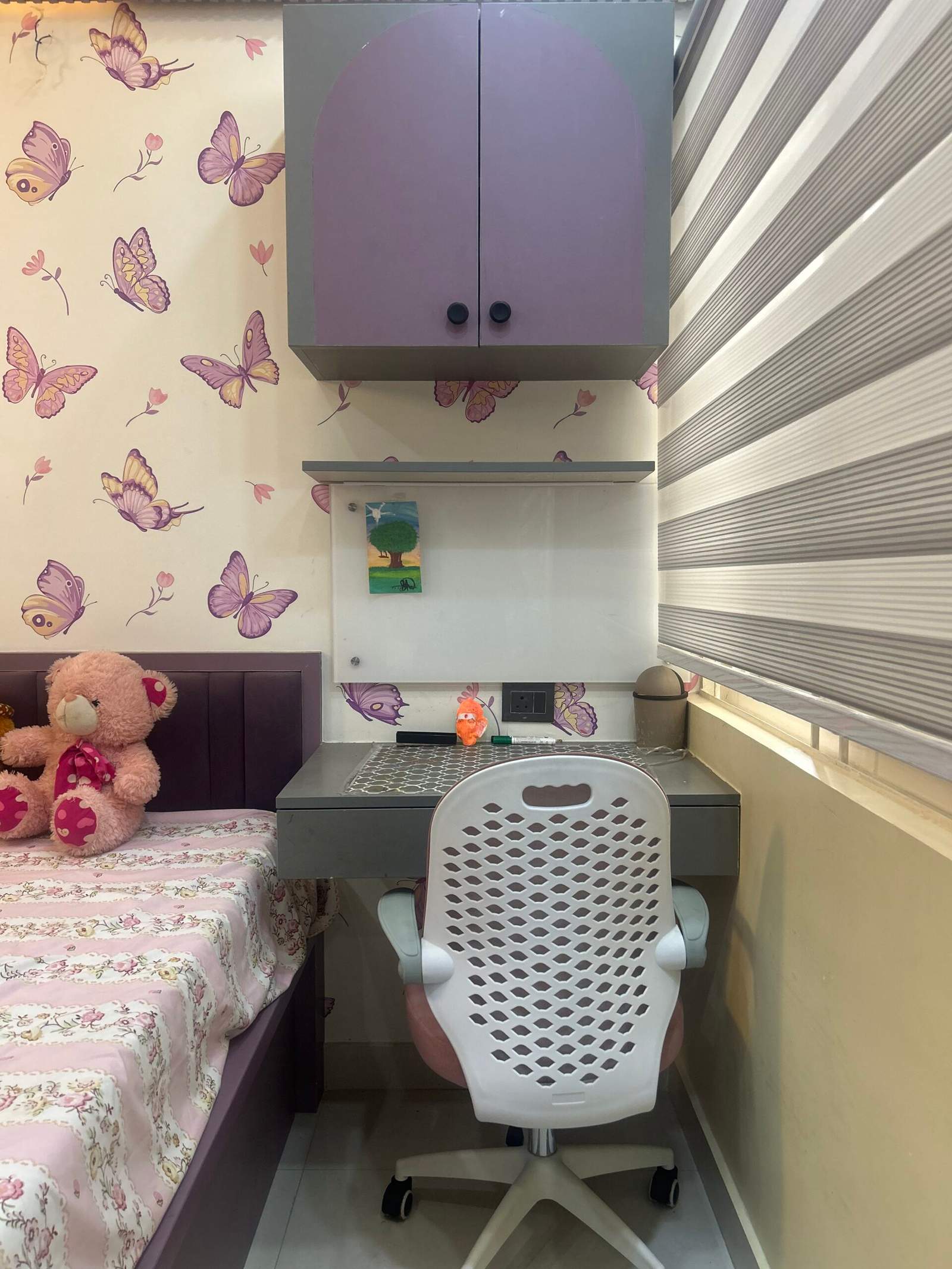 Modern bedroom with study table and mounted storage racks in Bangalore by Olangana Design’s.