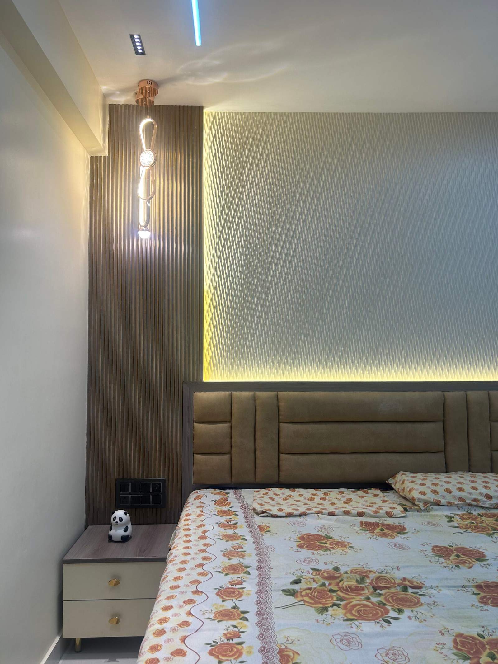 Modern bedroom interior with bedside table and lamp in a Bangalore home by Olangana Design’s.