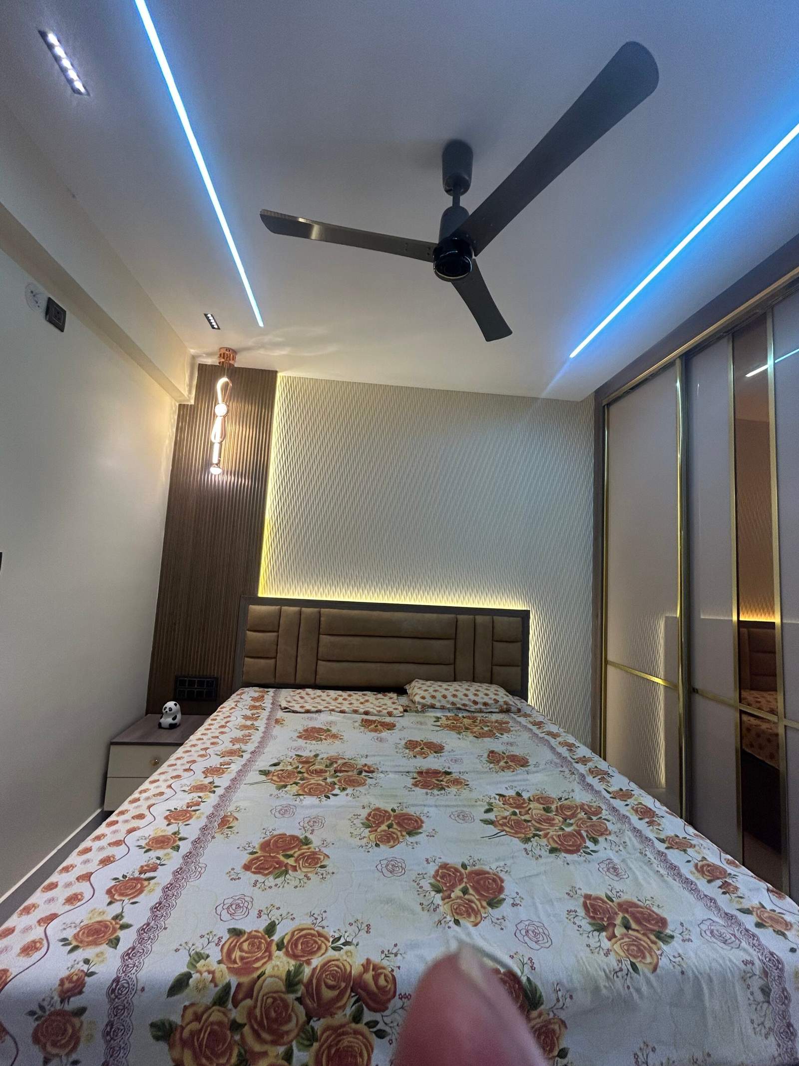 This bedroom interior features a sliding wardrobe made with standard-quality plywood that helps save space while maintaining a clean look. The bed is positioned to create a comfortable sleeping and relaxation area. Today, many homeowners prefer sliding wardrobes because they are practical for compact bedrooms and provide organized storage. This modern bedroom approach is commonly seen in Bangalore homes designed by Olangana Design’s.