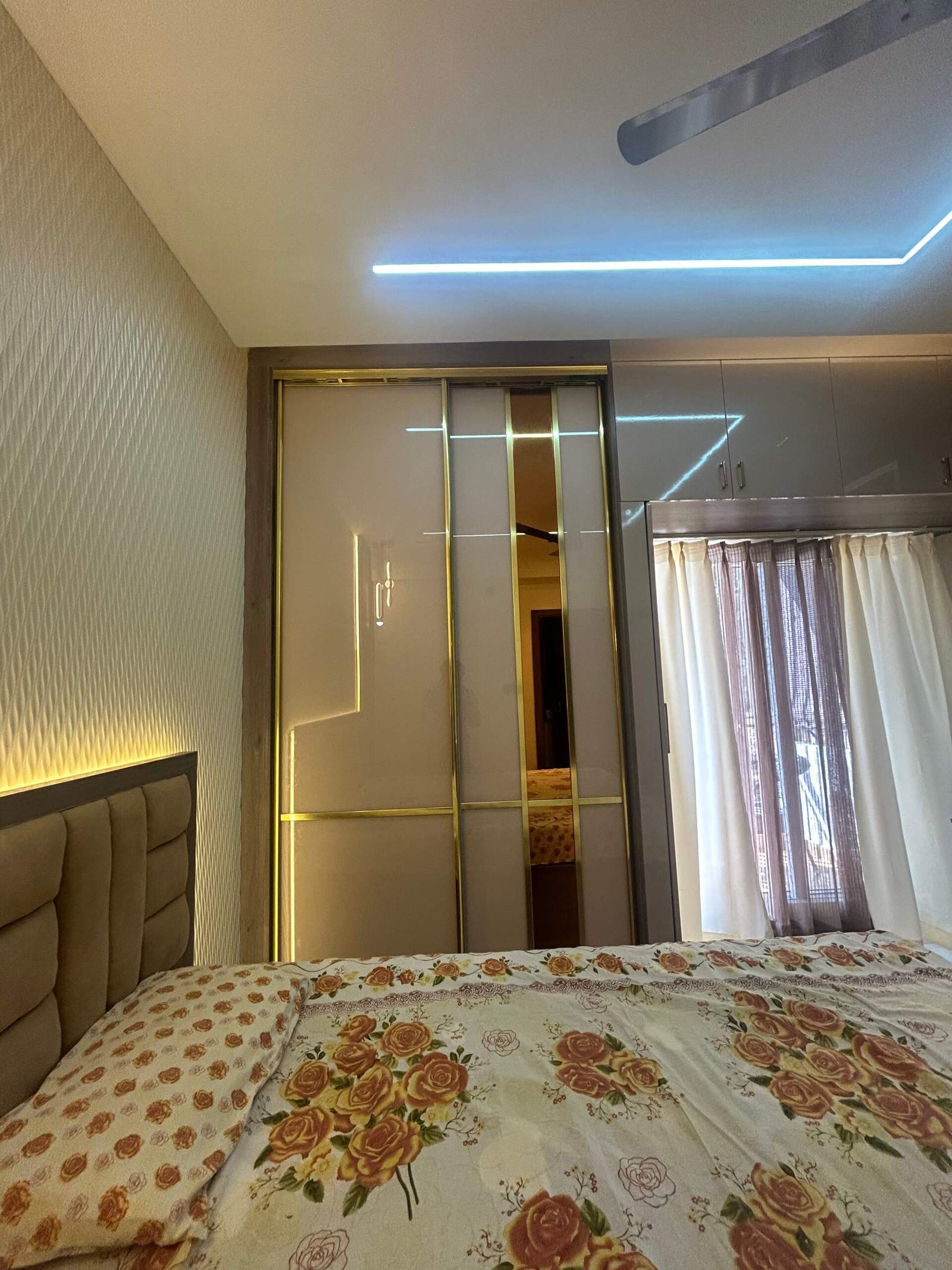 Modern bedroom interior with sliding wardrobe in a Bangalore home by Olangana Design’s.